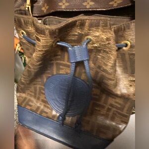 very damaged but exclusive Fendi with a vintage fe strap